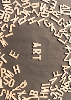 Art Word In Wooden Cube Alphabet Letters Top View On A rustic paper Background.