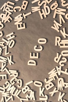 Deco Word In Wooden Cube Alphabet Letters Top View On A rustic paper Background.