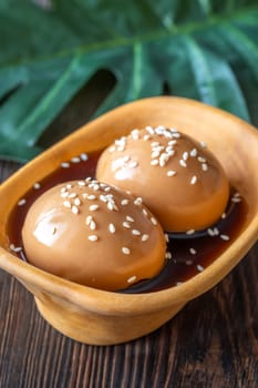 Soft-boiled ramen eggs soaked in savory marinade, garnished with sesame seeds