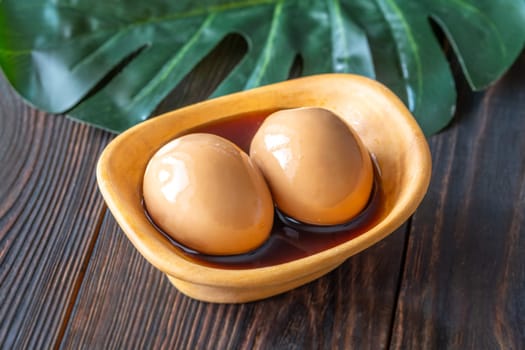 Soft-boiled ramen eggs soaked in savory marinade, garnished with sesame seeds
