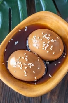 Soft-boiled ramen eggs soaked in savory marinade, garnished with sesame seeds