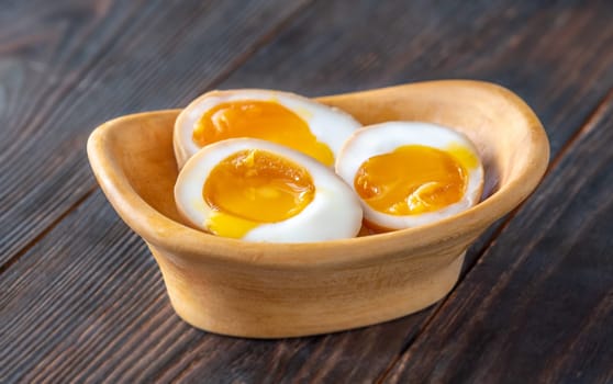 Soft-boiled marinated ramen eggs, halved to reveal rich, golden yolks