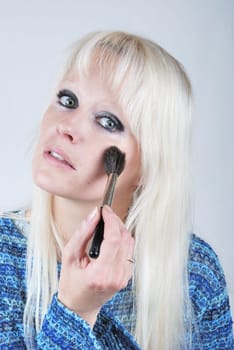 Woman applying makeup