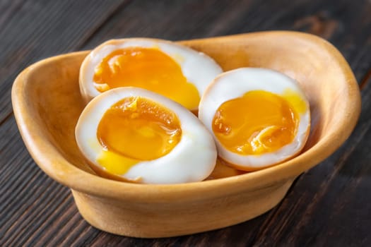 Soft-boiled marinated ramen eggs, halved to reveal rich, golden yolks