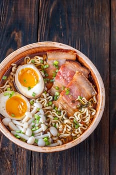 A steaming bowl of ramen filled with noodles, tender pork, and savory toppings