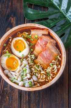 A steaming bowl of ramen filled with noodles, tender pork, and savory toppings