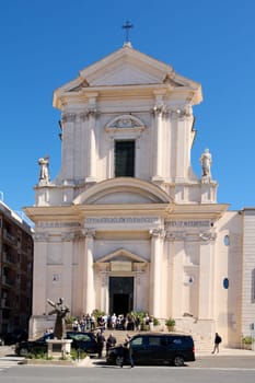 Civitavecchia. Italy - January 26, 2025: This image captures the majestic San Francesco Cathedral in Civitavecchia, Italy, with its neoclassical facade and bustling surroundings.