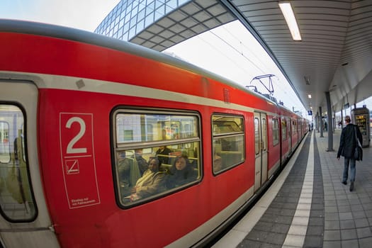 March 19, 2010: train enters the train station Messe in Frankfurt with view to skyline.