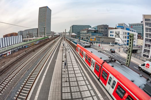 March 19, 2010: train enters the train station Messe in Frankfurt with view to skyline.