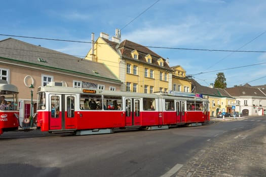 Vienna, Austria - April 27, 2015:  view to center of Grinzing in Vienna in early morning with nearly empty streets and streetcar.