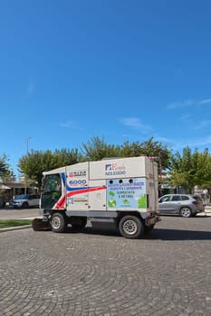 Civitavecchia, Italy - January 27, 2025: Eco-friendly urban cleaning vehicle parked on a cobblestone street. The vehicle runs on methane and bears several logos, including that of Dulevo International