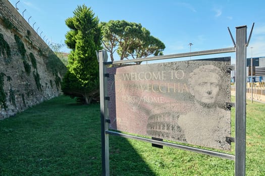 Civitavecchia, Italy - February 02, 2025: A vintage welcome sign with cracks and faded text, symbolizing the passage of time in a historic trade city. Concept: maritime, history, time
