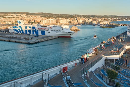 Civitavecchia, Italy - February 02, 2025: Industrial port scene with a docked ferry, cargo trucks and loading areas, reflecting Italy's maritime trade. Concept: industrial, export, cargo.