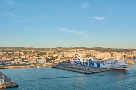 Civitavecchia, Italy - February 02, 2025: Aerial view of a commercial harbor with freight trucks and shipping containers, illustrating maritime infrastructure. Concept: shipping, logistics, supply.