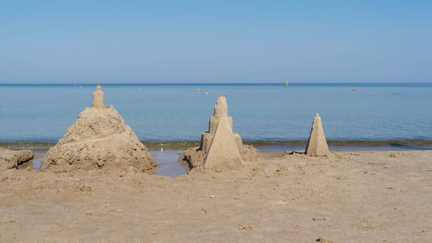 Sandcastles on the beach of Kolobrzeg on the Polish Baltic coast in summer
