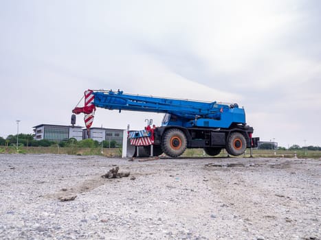 Construction site crane is lifting a led signboard Blank billboard on blue sky background for new advertisement