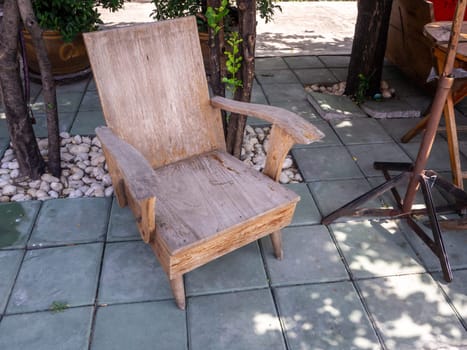 The old hardwood in garden chair with tree.