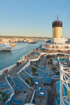 Civitavecchia, Italy - February 2, 2025: Vew from a tourist cruise ship of the commercial port of Civitavecchia in Italy. With the cruise ship deck and the city of Civitavecchia in the background.