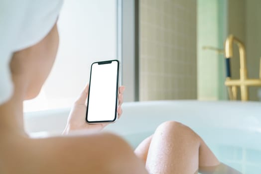 phone blank screen display in woman hand, relax in bathtub with smartphone in morning time