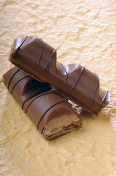 a chocolate bar with a filling on a yellow background