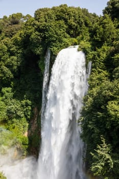 Marmore waterfall in Umbria region, Italy. Amazing cascade splashing into nature with trees and rocks.