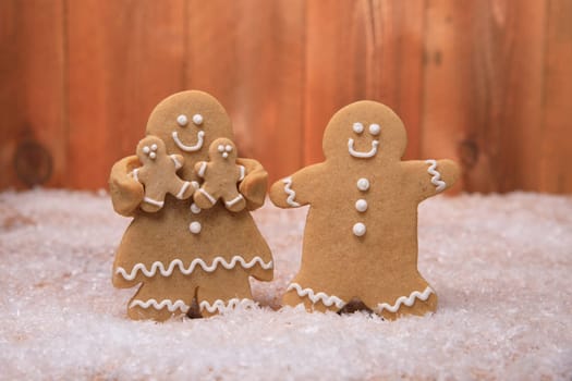 Gingerbread Family of 2 kids on Holiday Christmas Background