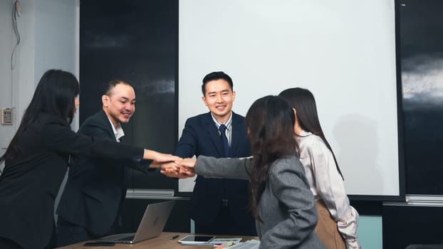 Business people join putting hands as team during their meeting, Stack of hands coming together of teamwork, Business group winning successful company achieving goals with determined staff