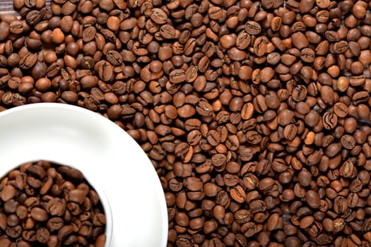 White coffee mug filled with fragrant coffee beans. High quality photo
