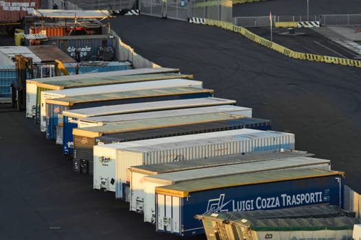 Civitavecchia. Italy - February 07, 2025: Industrial transport area with cargo containers in an international port. Concept: Maritime trade and freight transportation