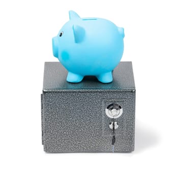 Blue ceramic piggy bank standing on a safe, isolated on white background. Bank savings, economy, financials investments, saving to buy a house, a car, for retirement concept.