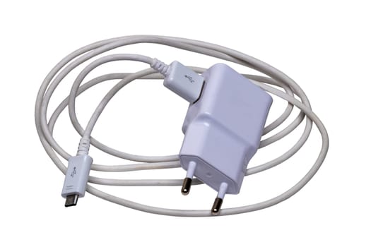Closeup of a adapter charger with USB cable with Micro USB isolated on a white background. Macro photograph of a Smartphone or iphone battery charger.