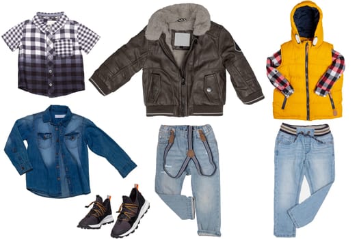 Collage set of little boy autumn clothing isolated on a white background. Denim trousers jeans and shirt, a pair sneaker, a leather jacket and warm vest with hood for child boy. Kids winter fashion.