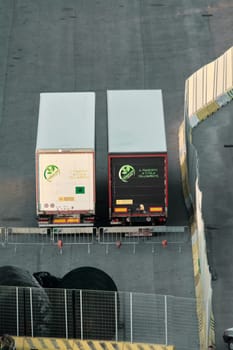 Civitavecchia, Italy - February 6, 2025: Cargo yard with cargo containers, illustrating the importance of transport logistics in trade. Concept: Heavy transport and road transport industry