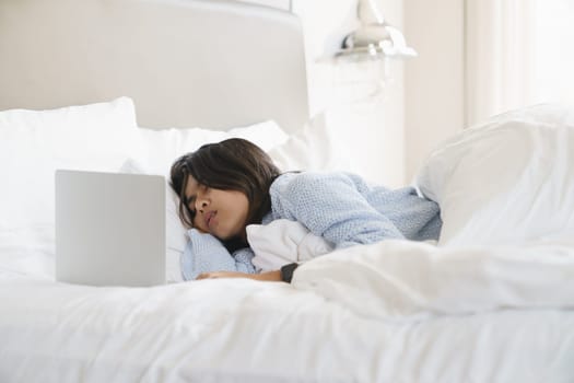 woman sleeping after use computer overwork on bed