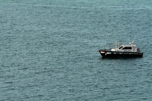 Civitavecchia. Italy - February 07, 2025: A pilot boat floats on the high seas, essential for maritime logistics and port operations. Concept: Nautical transport and safety