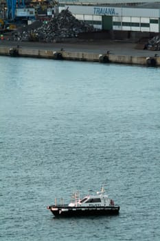 Civitavecchia. Italy - February 07, 2025: Harbour pilot vessel. facilitating the entry and exit of large cargo ships. A key role in maritime transport operations. Concept: Maritime navigation services