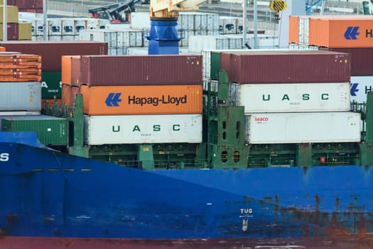 Civitavecchia. Italy - February 7, 2025: Cargo containers stacked on a ship docked in the port. It represents global trade and import and export industries Concept: Global trade and maritime logistics