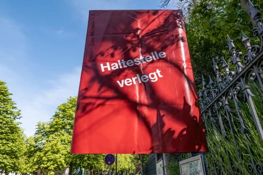 Wiesbaden, Germany - May 9, 2021: sign Haltestelle verlegt (Busstop changed due to detour) under blue sky.