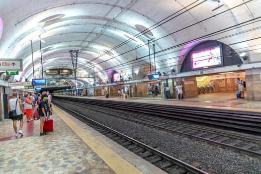 Rome, Italy - August 1, 2021: people wait for the next Metro at train station Termini in Rome.