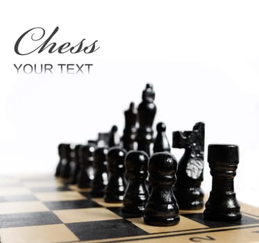 Black chess pieces on chess board isolated over white