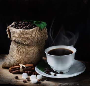 Coffee concept with coffee beans and fresh coffee leaves