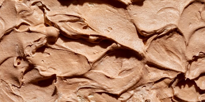 Background texture of the surface of creamy caramel or toffee ice cream in a wide angle panorama for menu, product or catering advertising