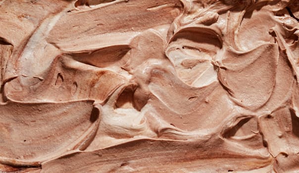 Tasty homemade or craft chocolate or caramel ice cream in a close up background texture for a design template or advertising in a full frame view