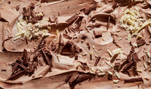 Chocolate ice cream dessert with flaked almonds and chocolate shavings topping in a full frame background texture for menu advertising