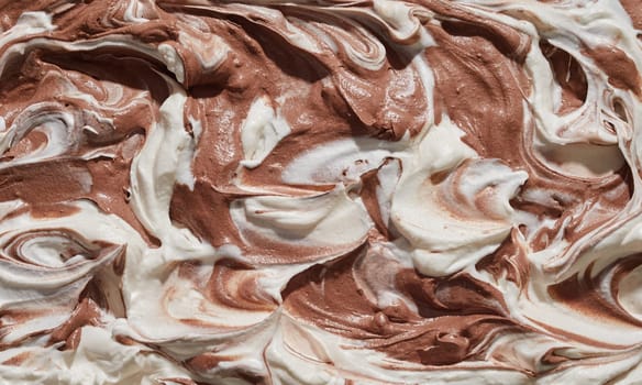 Homemade speciality chocolate and vanilla ice cream texture in a full frame view of the surface of the dessert with swirls and ridges for menu advertising