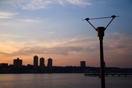 The pole with the connectors during a sunset on the Hudson river in New York City