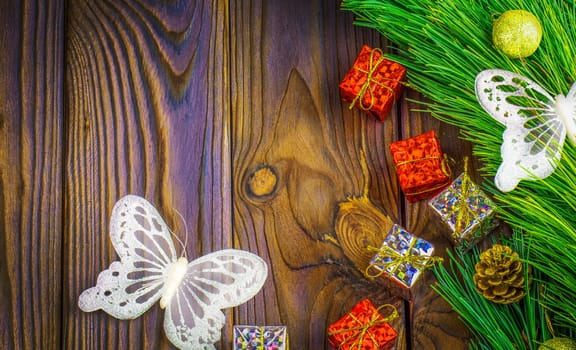 The fir-tree with toys, white butterfly and gifts. Background. Selective focus