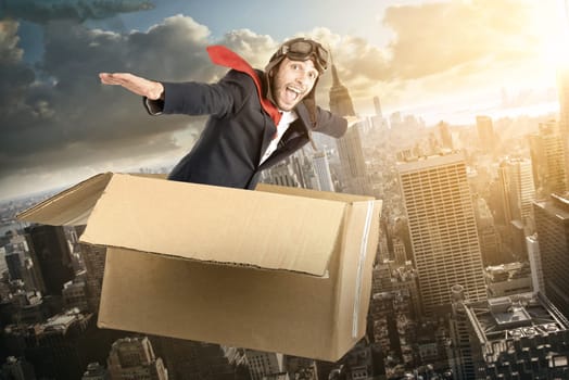 Businessman flying a carboard box over the skies