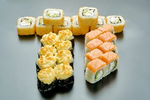 A set of delicious and juicy sushi on a black stand. High quality photo