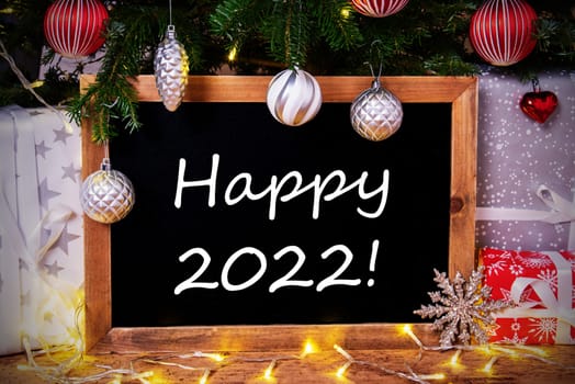 Blackboard With English Text Happy 2022. Christmas Tree With Ball, Gifts And Fairy Lights